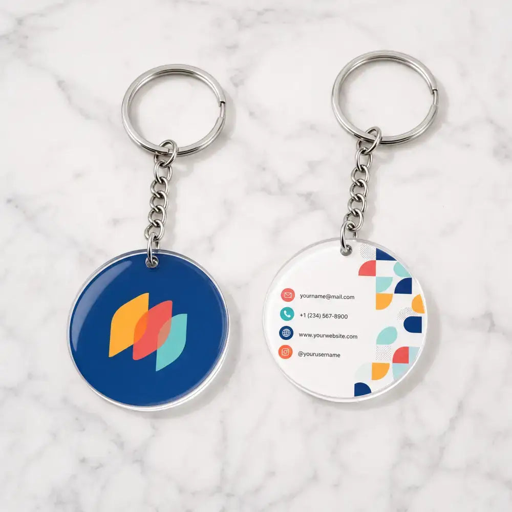 Two keychains with colorful designs on a marble surface