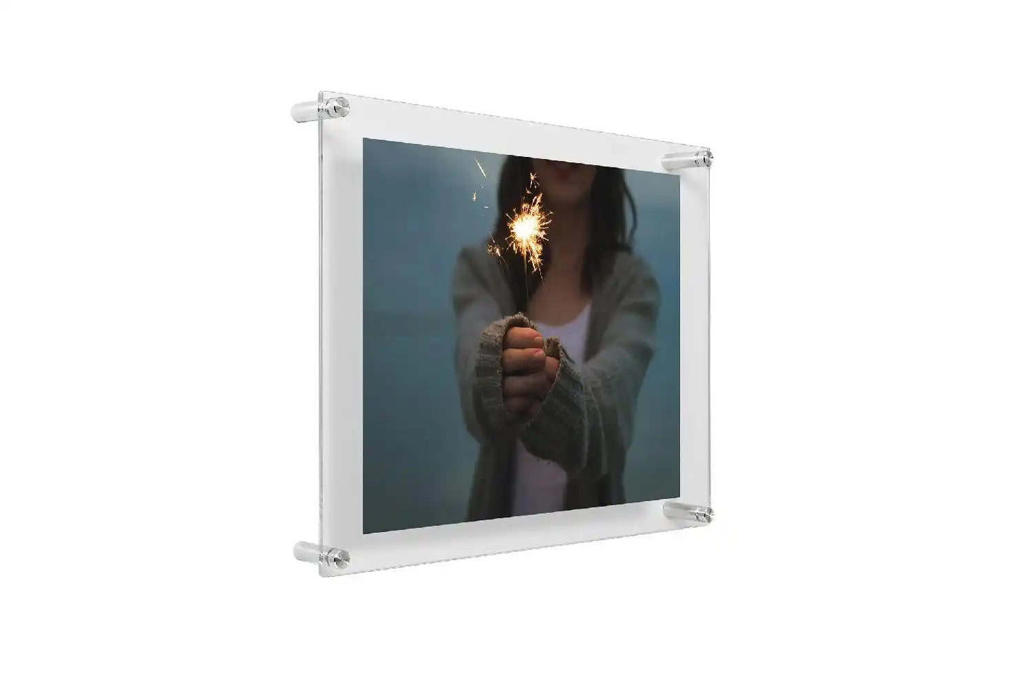 Clear acrylic floating frame displaying a photograph of hands holding a lit match.