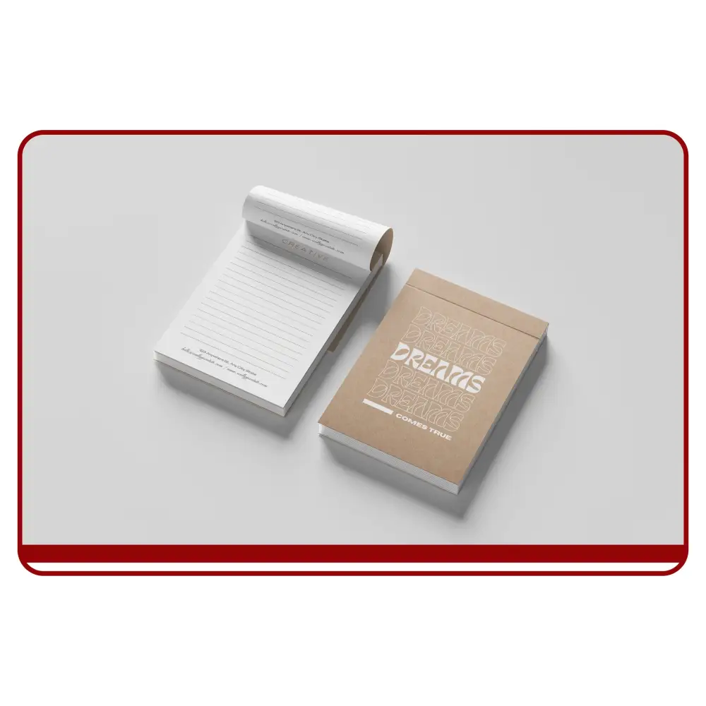 Notebook and box with 'Dreams' text on a light gray background