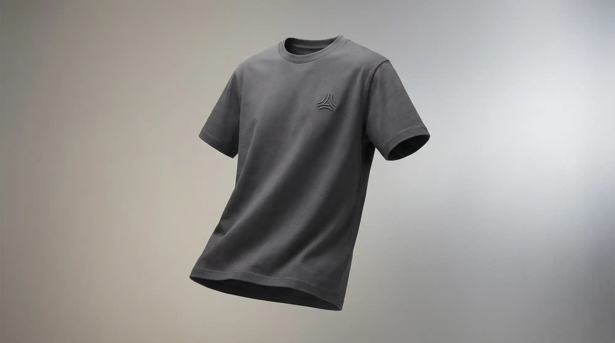 Dark gray short-sleeved t-shirt with a subtle embroidered logo on the left chest.