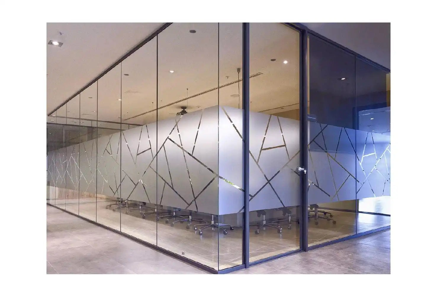 Glass partition wall with geometric line patterns etched into the surface.