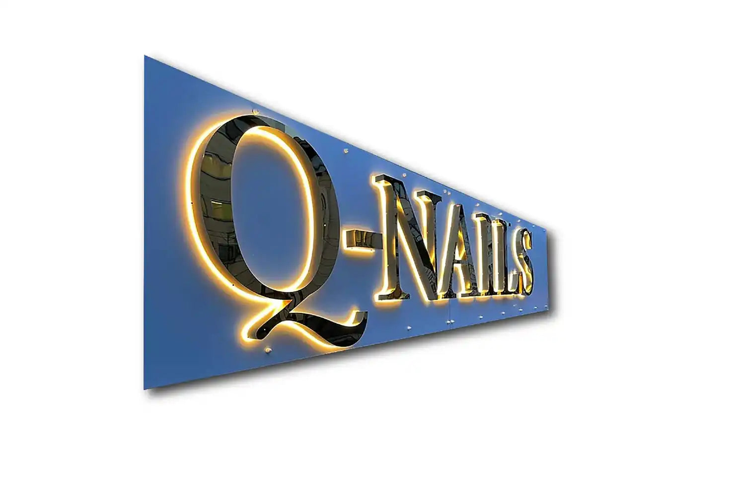 Illuminated business sign reading ’Q-NAILS’ with gold lettering against a blue background.